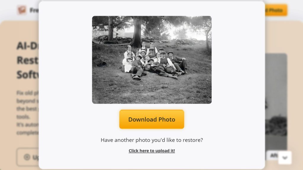 Black and white group photo of people sitting on grass under trees posing for the camera in a park like setting Image